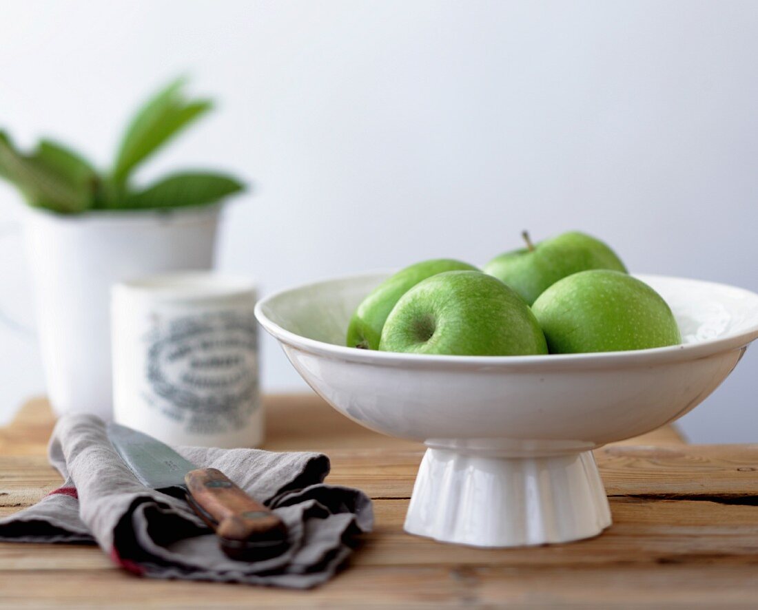 Green apples in a white dish
