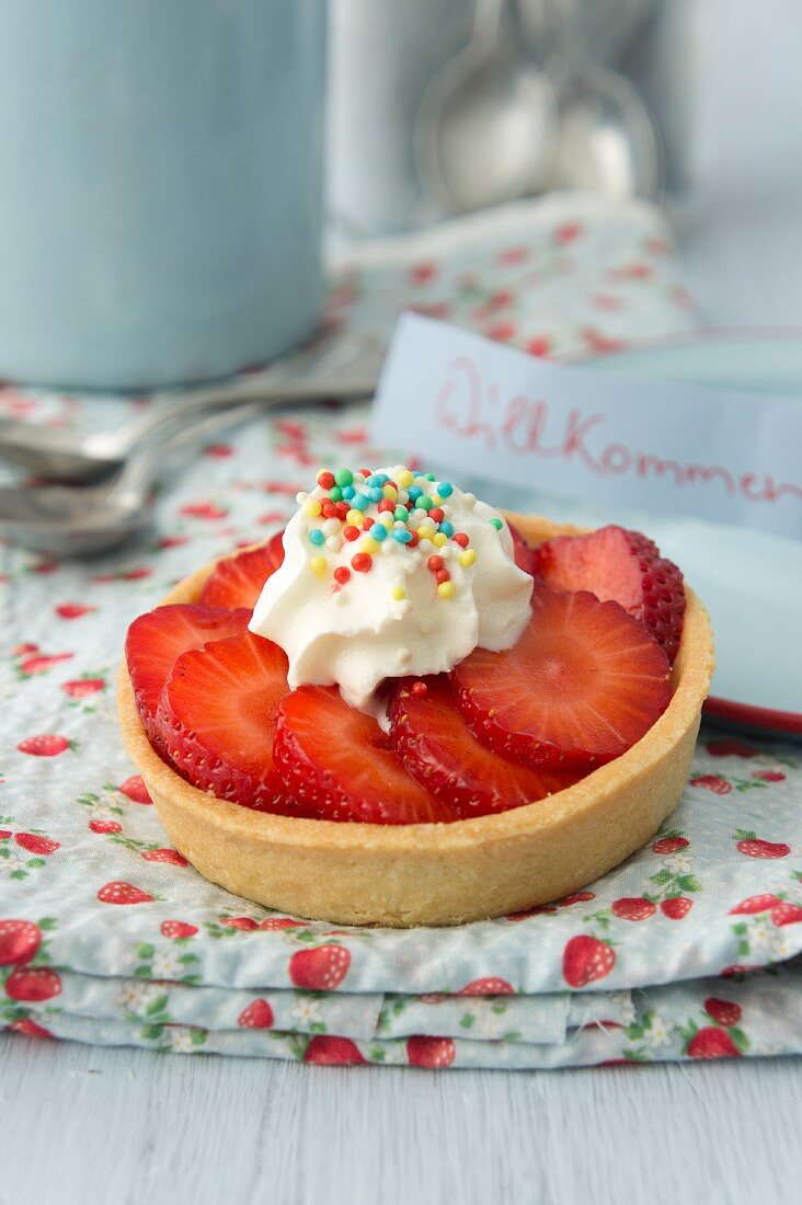 Strawberry tartlet with colourful sugar sprinkles