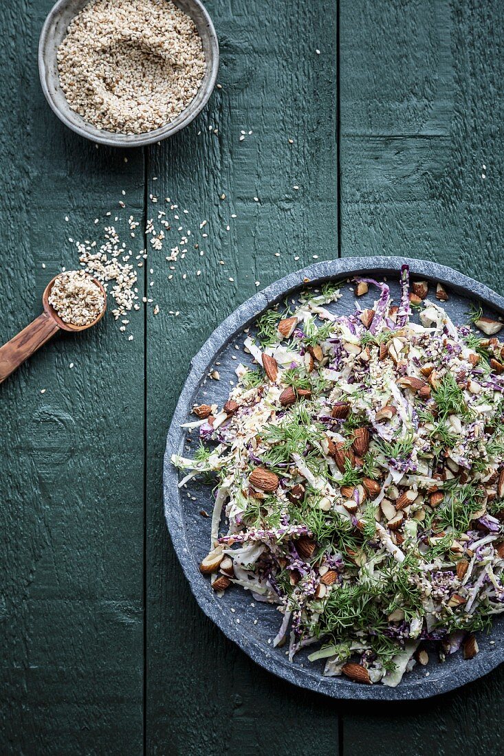 Cabbage and fennel salad with almonds, sesame seeds and fennel leaves