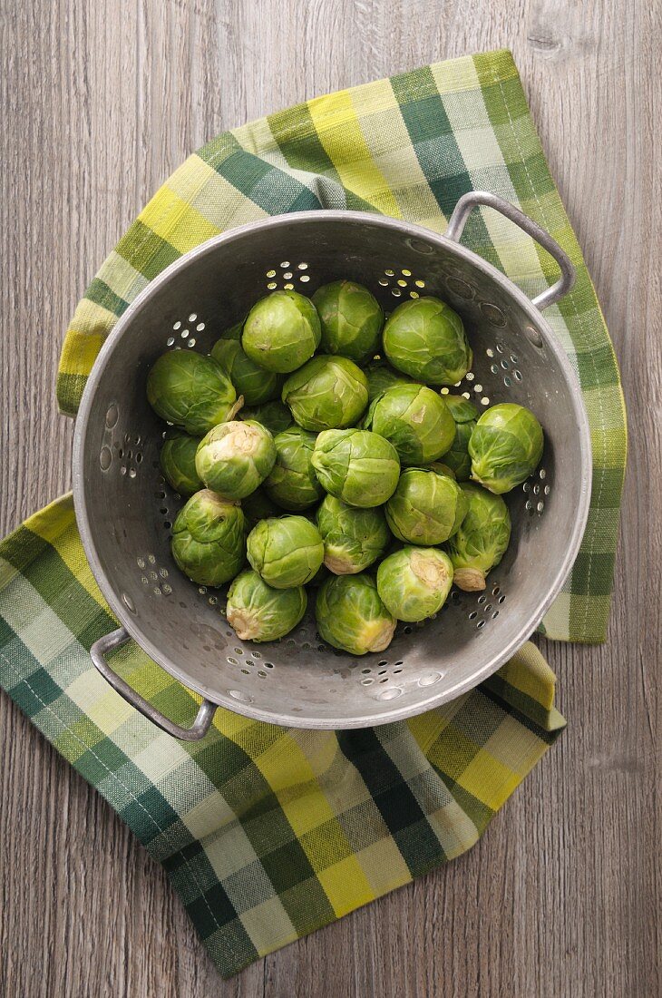 Fresh Brussels sprouts in a colander (seen from above)