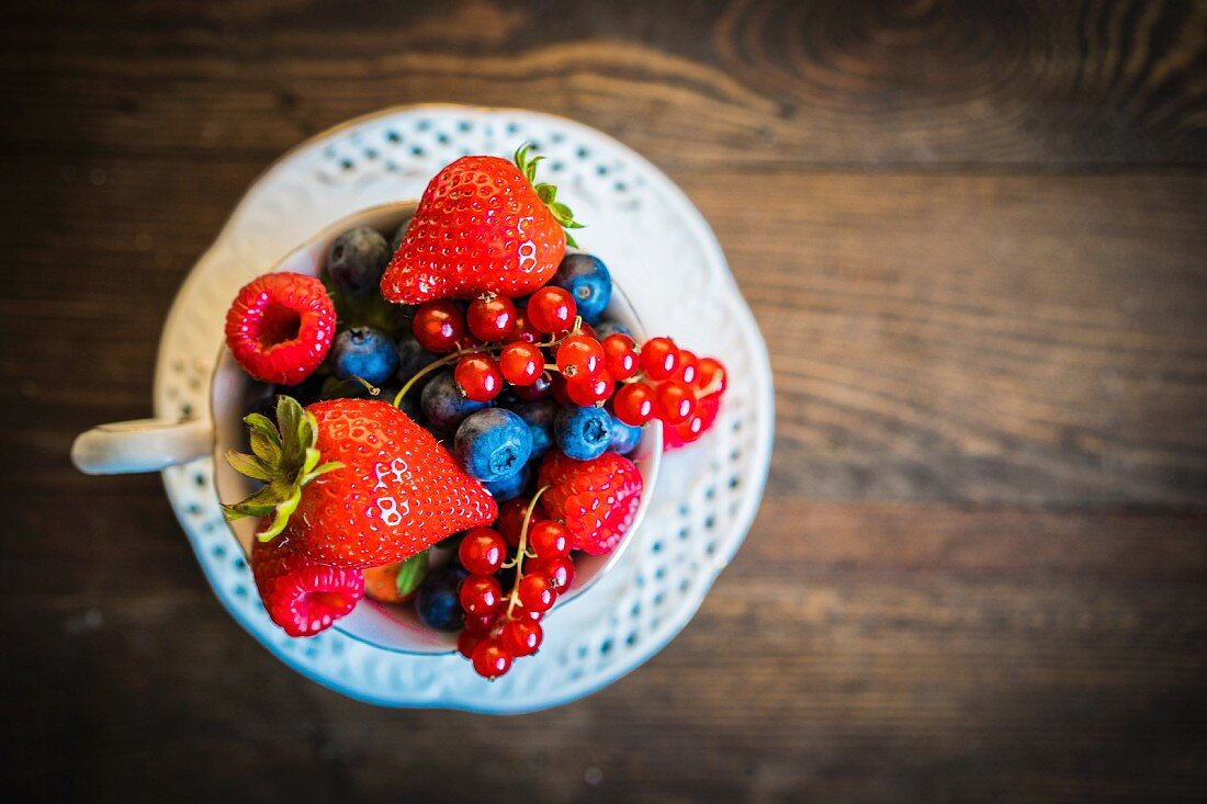 Fresh summer berries in a teacup