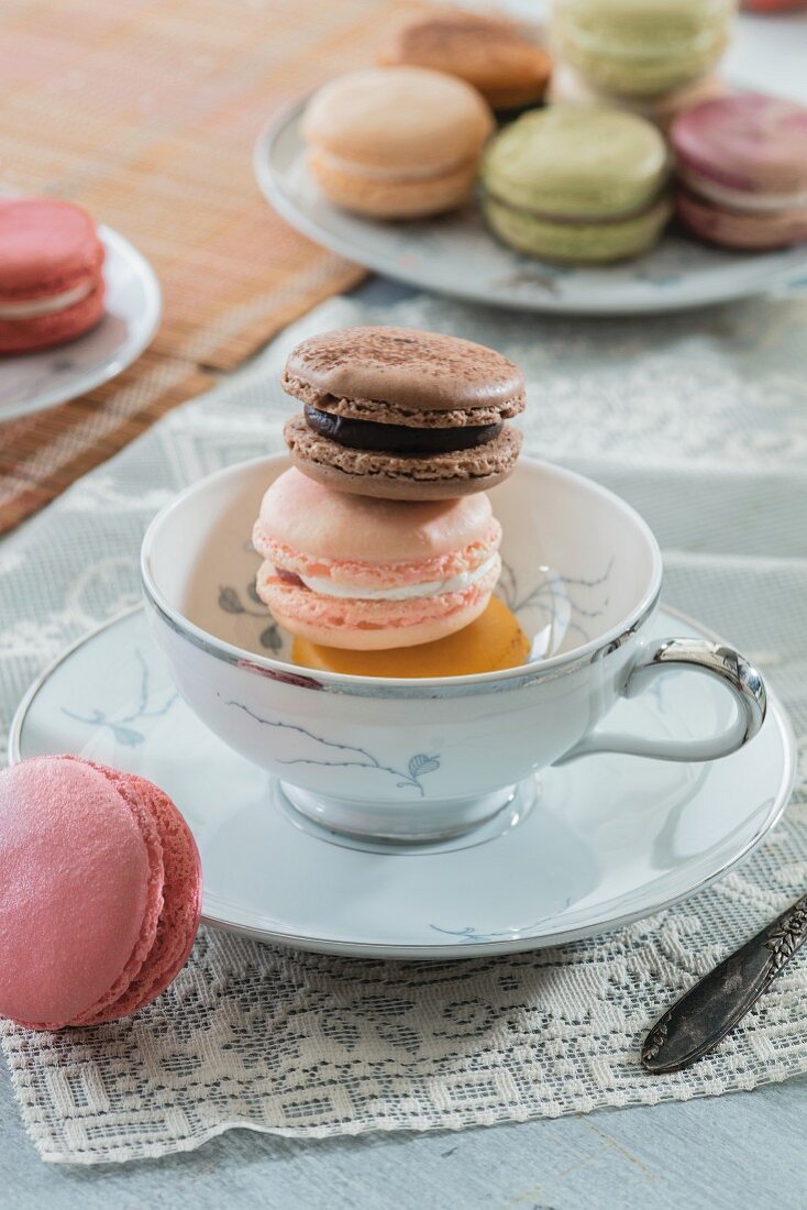 Macaroons in a tea cup and on a plate