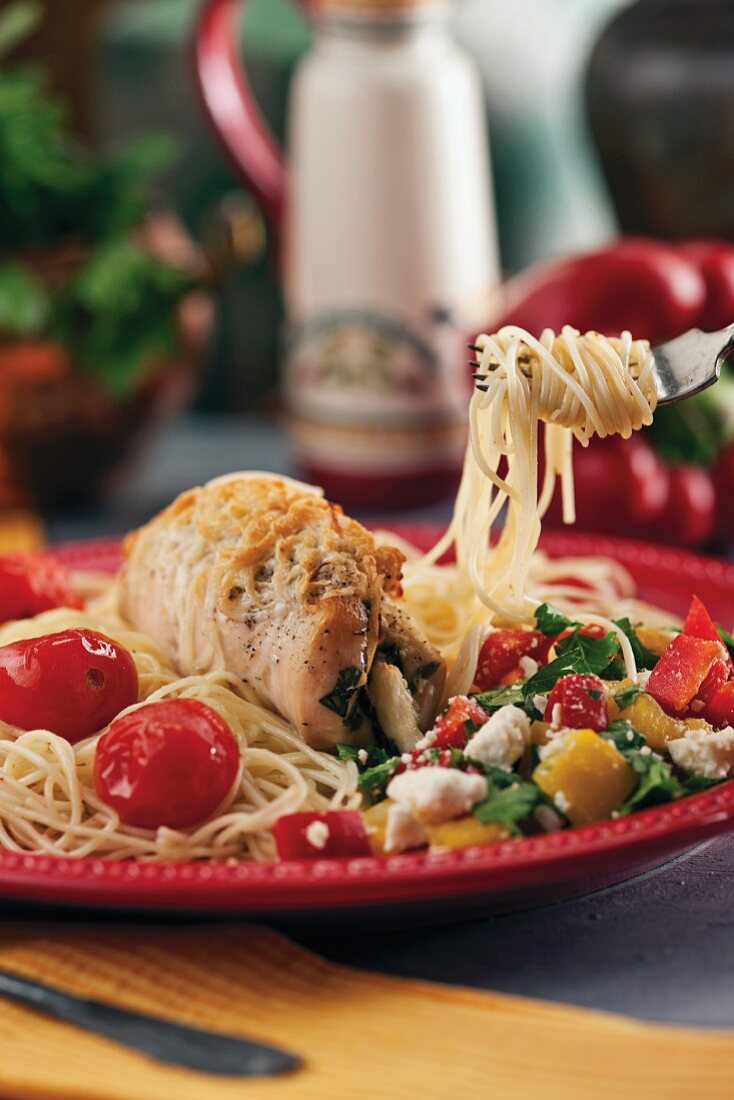 Stuffed turkey roulade on pasta with vegetables