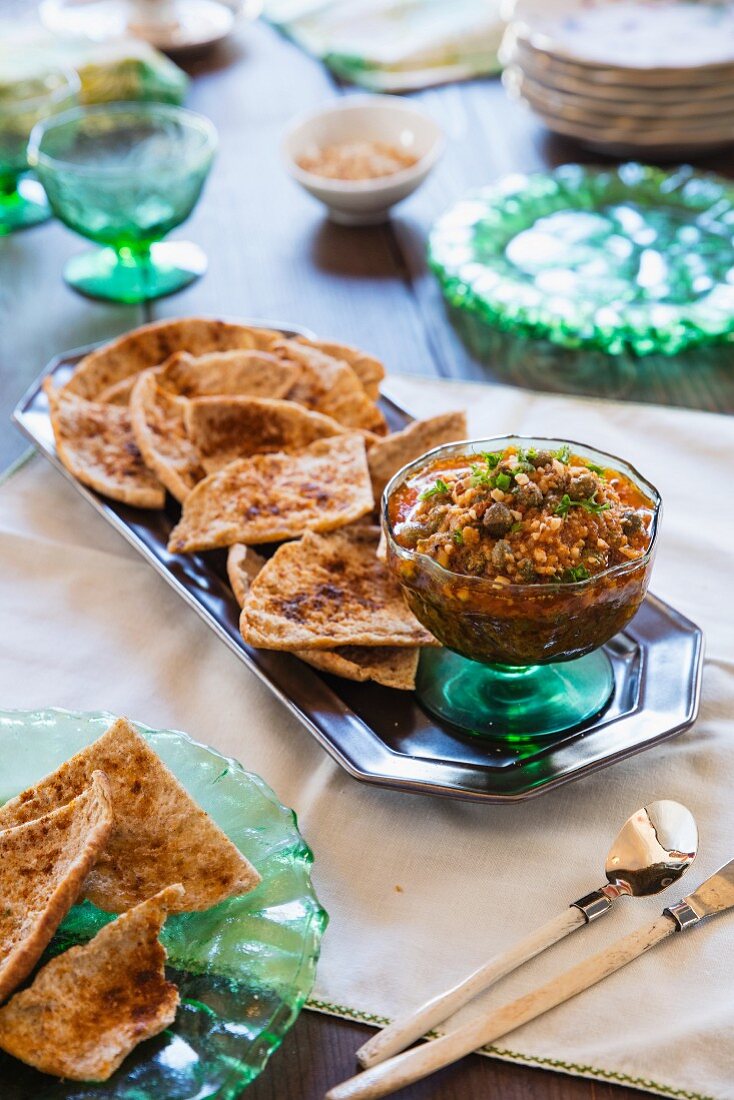 Pita chips with an almond and caper dip