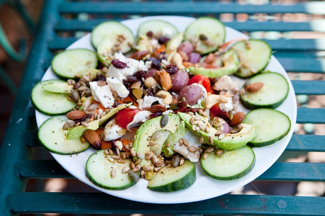 Cucumber salad with avocado, cashew nuts, seeds and olives