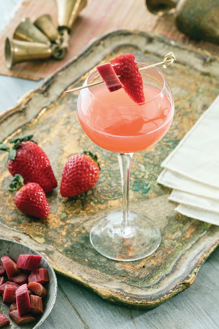 A champagne cocktail with rhubarb and strawberries