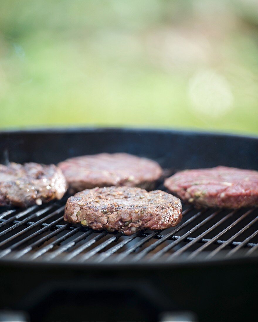 Lean beef burgers on a barbecue