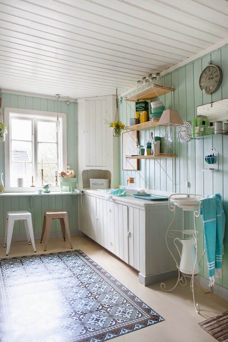 Board walls and plastic rug with faux tiled pattern in Bohemian kitchen