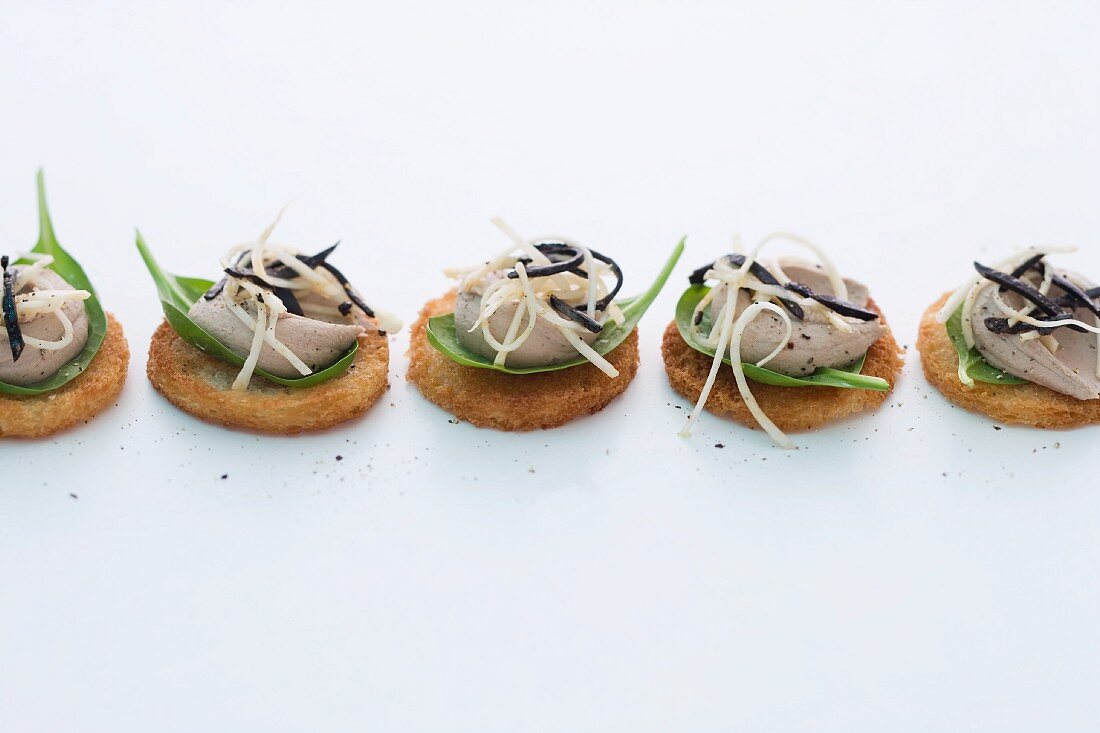 Crostini topped with duck liver mousse, celeriac and truffles