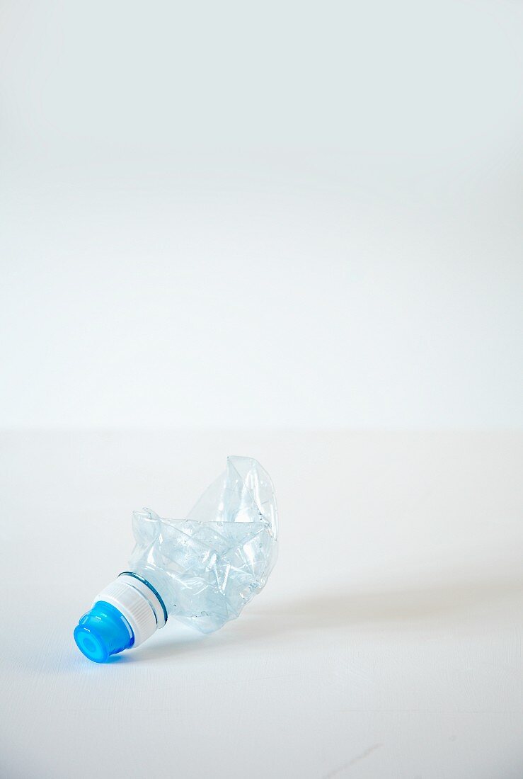 An empty squashed plastic water bottle