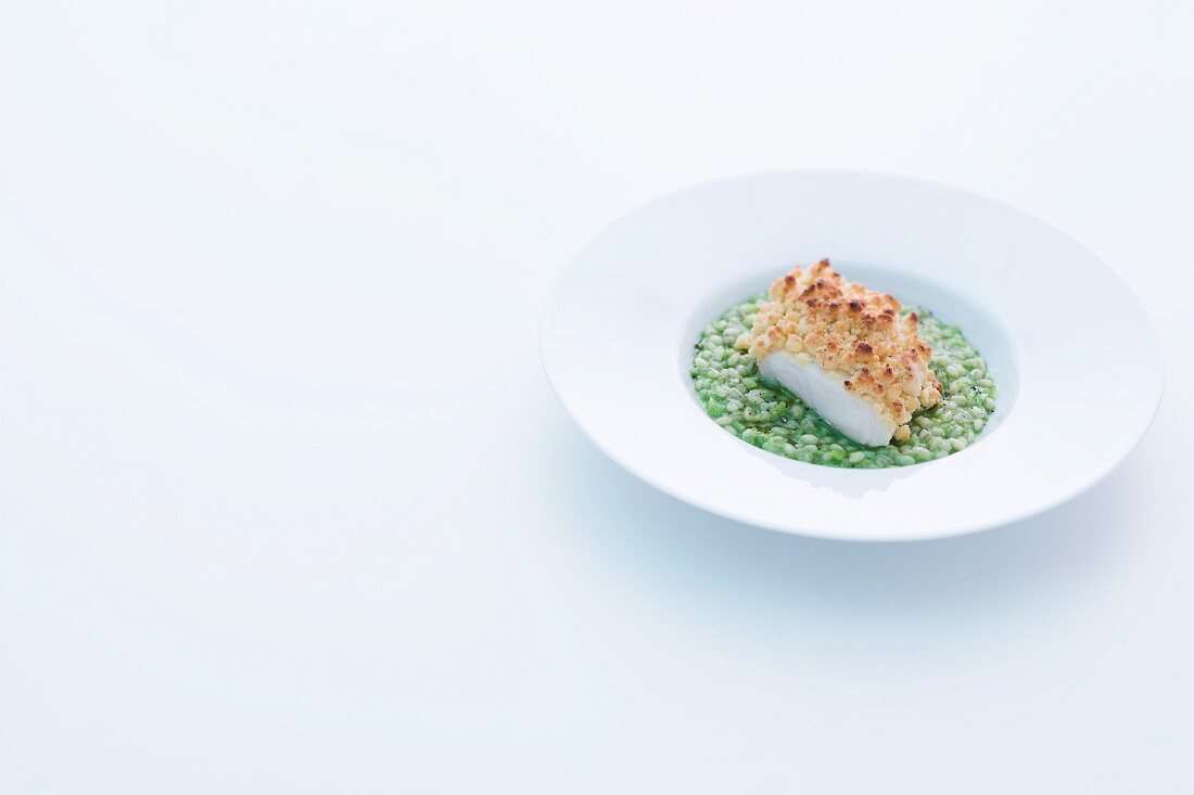 Catfish fillet with a horseradish crust on green pearl barley