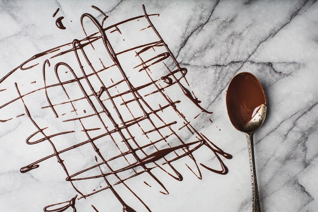 A lattice of melted organic dark chocolate on marble surface