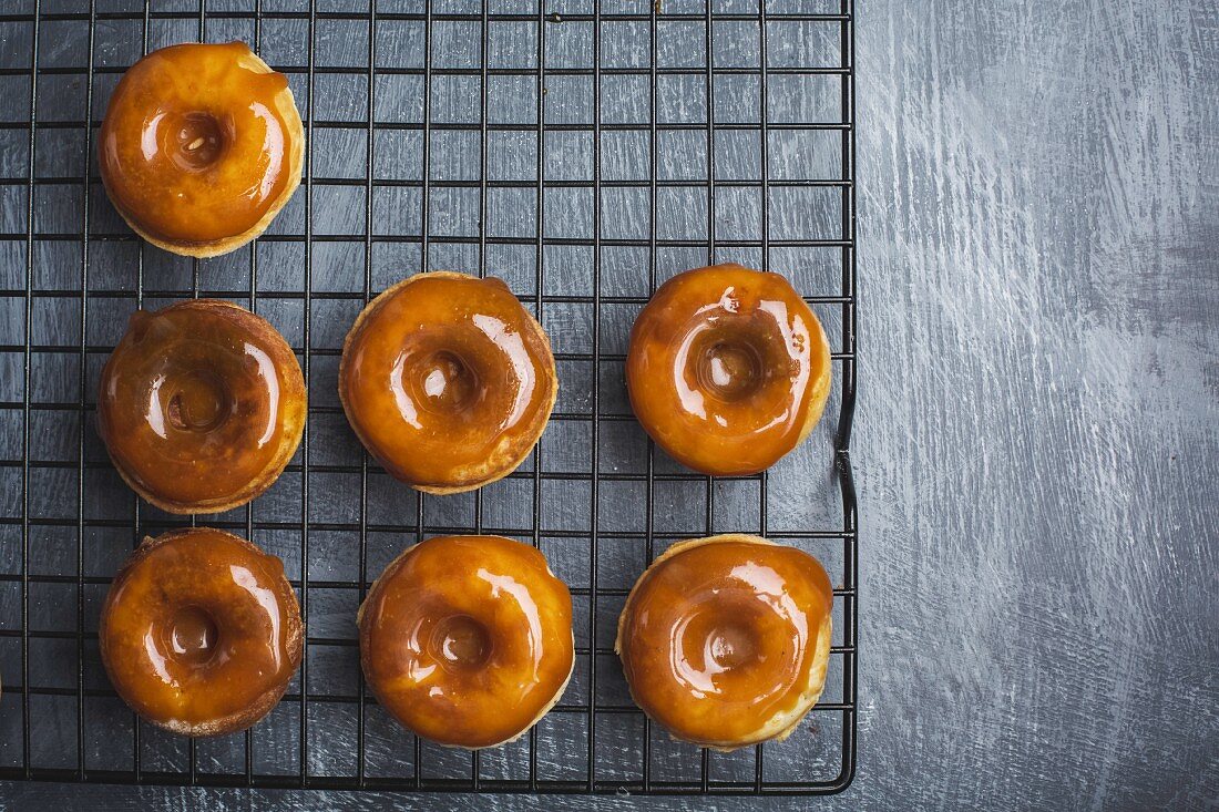 Doughnuts with salted caramel glaze on a wire rack