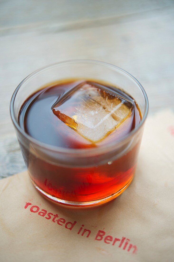 Cold coffee with an ice cube in a glass, roasting house and cafe 'The Barn', Berlin