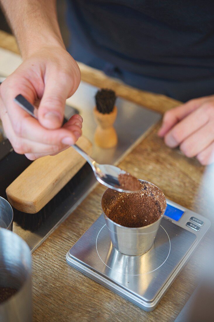 Ground coffee being weighed at the roasting house and cafe 'The Barn' in Berlin