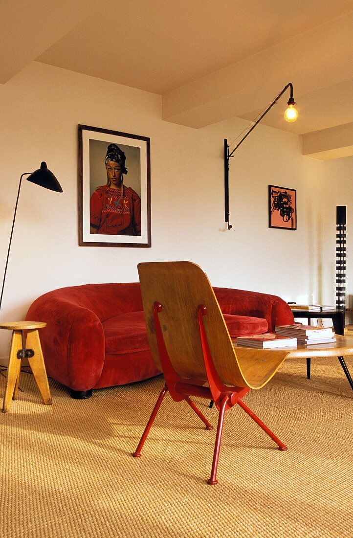 Red sofa and wall-mounted lamp in living room