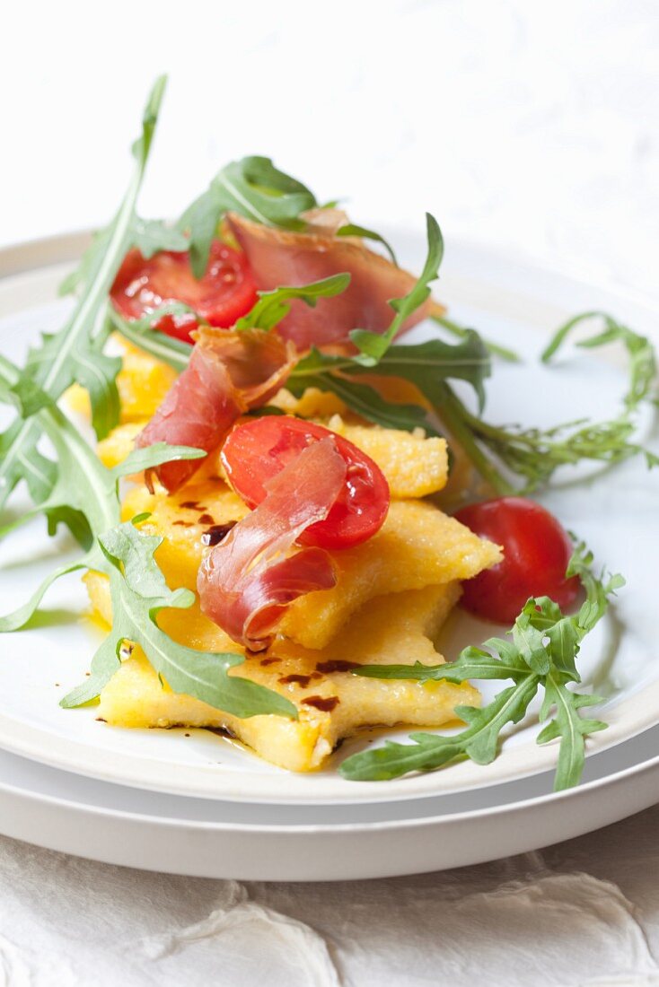 Polentasterne mit Rucola, Schinken und Tomaten