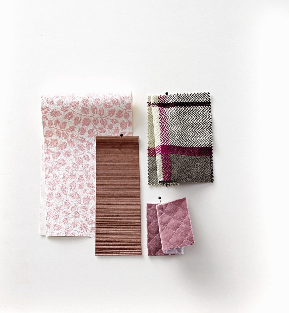 Pinned fabric and wallpaper swatches in purple tones