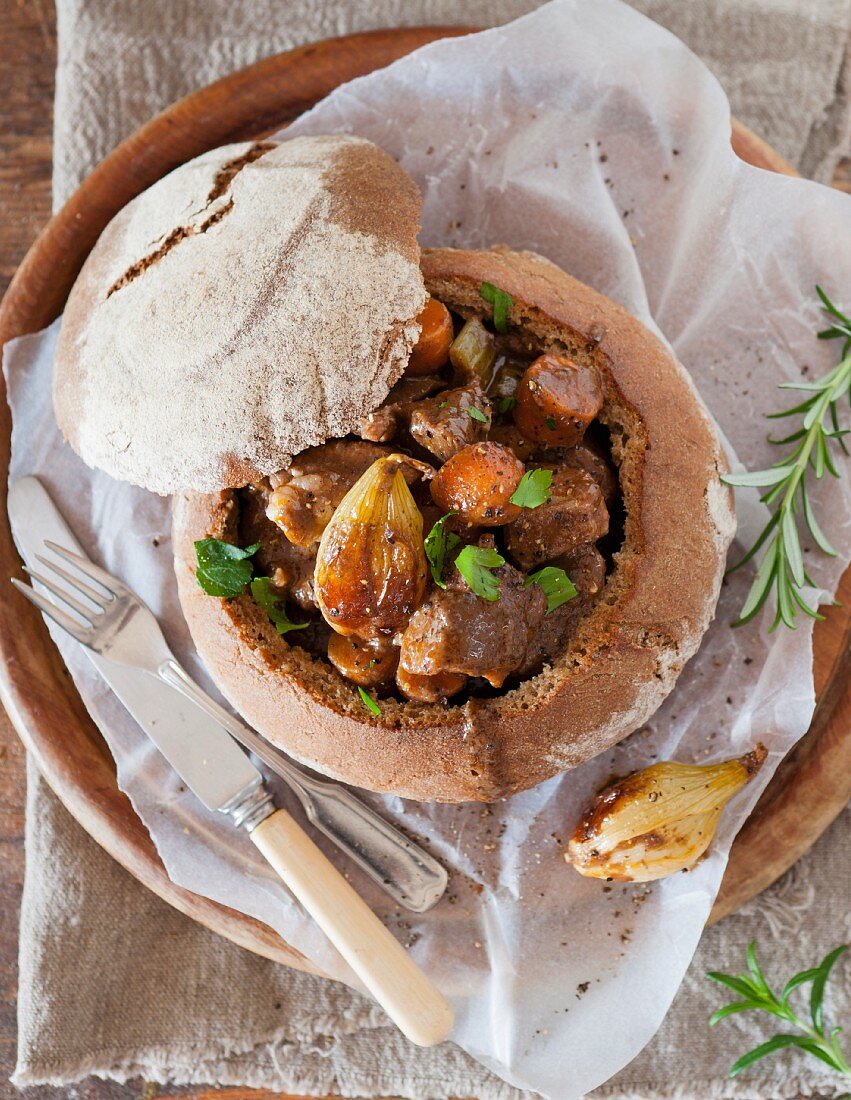 Beef stew served in a loaf of bread