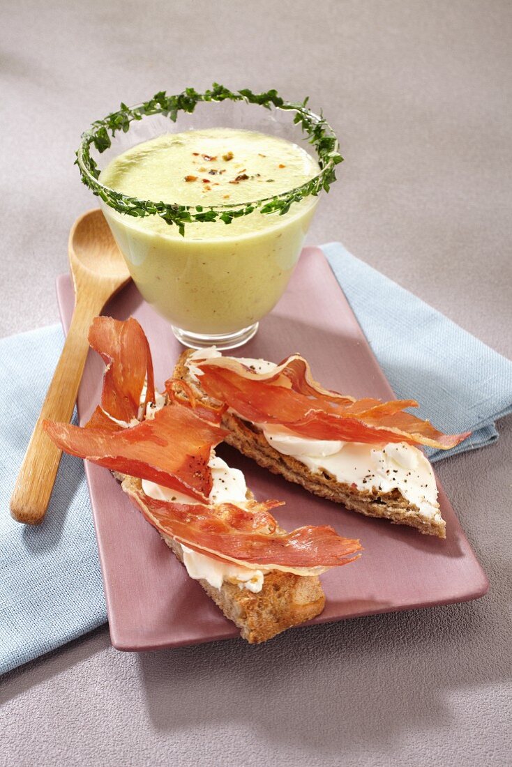 Grilled bread topped with raw ham served with cold cream of cucumber soup