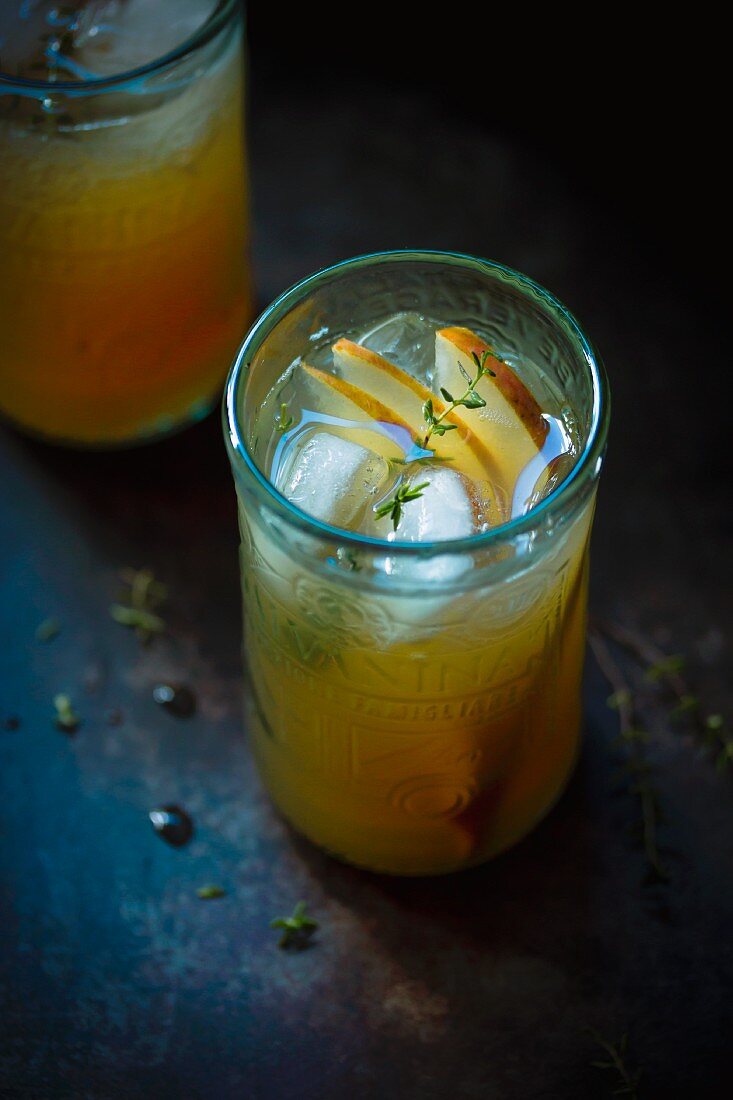 Rum punch cocktail with thyme and pear