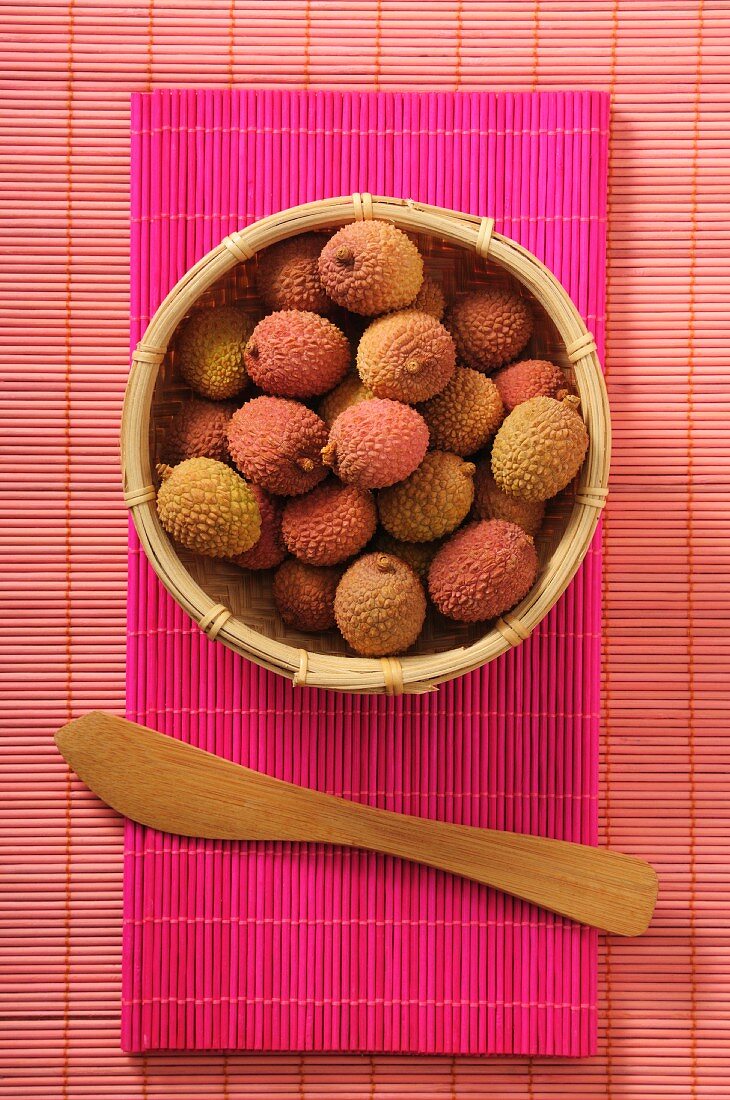 Fresh lychees in a bamboo basket (seen from above)