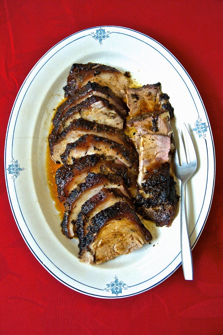 Roasted leg of lamb sliced on a serving platter