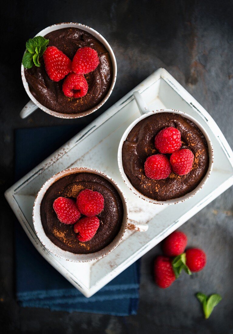 Cups of vegan chocolate mousse with raspberries