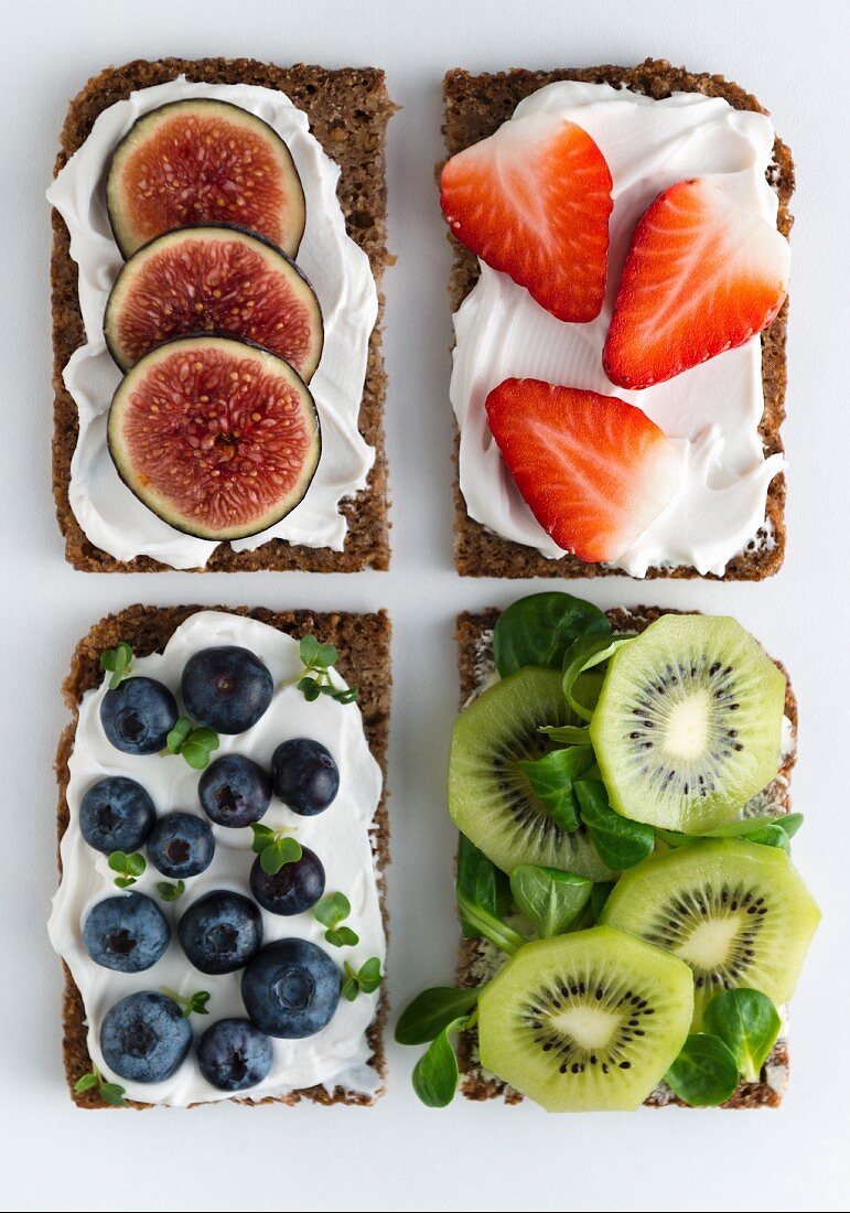 Open wholemeal sandwiches topped with soya quark and various fruit