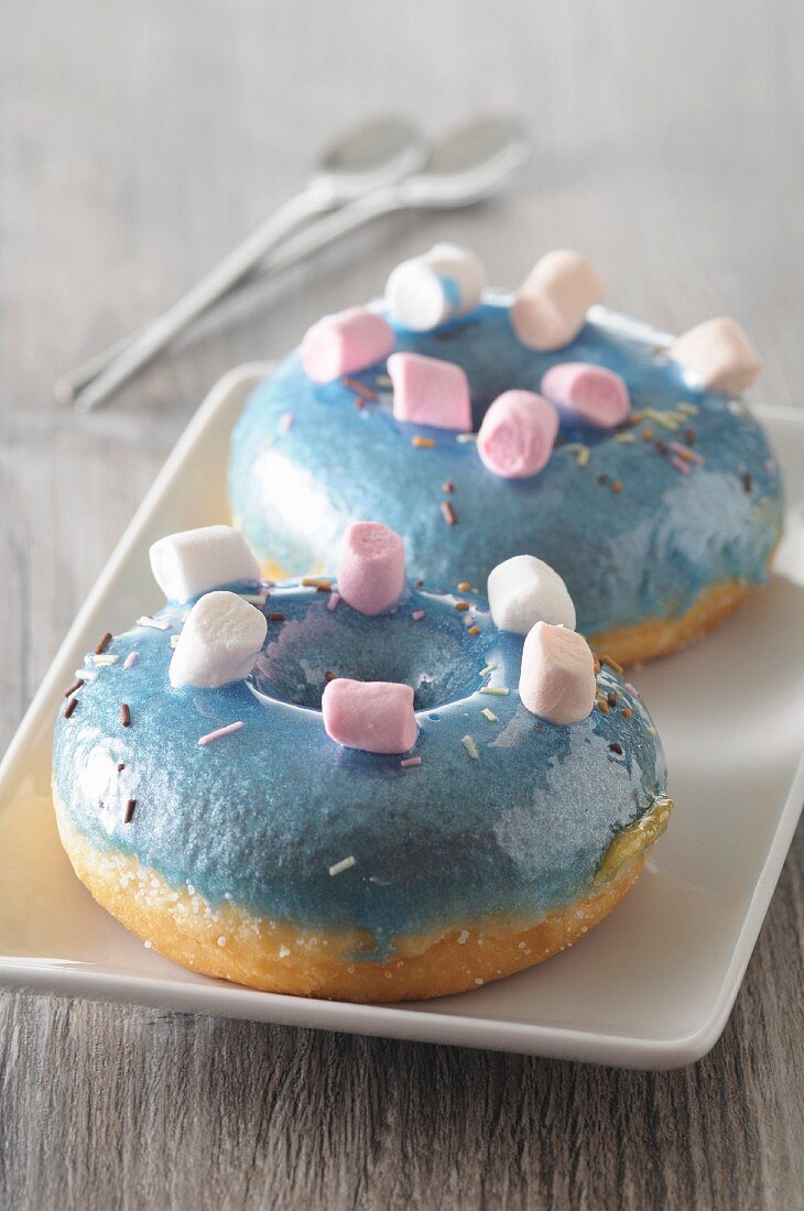Blue doughnuts topped with marshmallows
