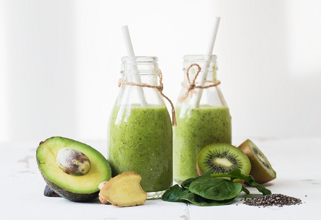 Green smoothies with avocado, kiwi, spinach, ginger and chia seeds