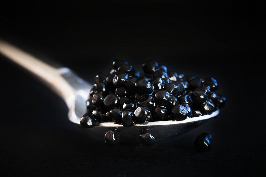 Black herring caviar on a spoon