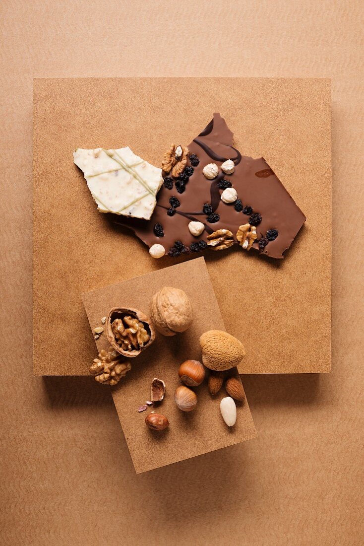 Chocolates and a nut mixture consisting of almonds, walnuts and hazelnuts on a cardboard box