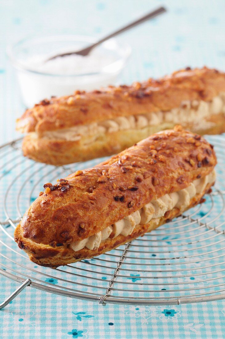 Two Paris Brest (cream-filled eclairs, France) on a wire rack