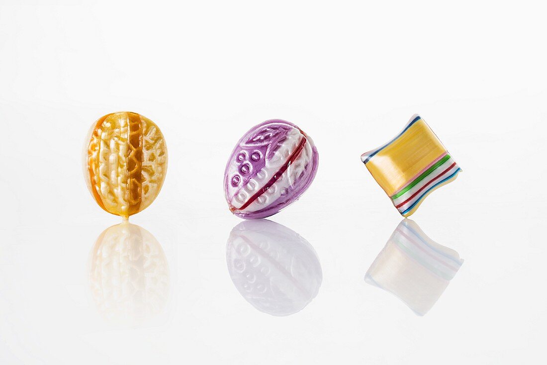 Colourful sweets on a white reflective surface
