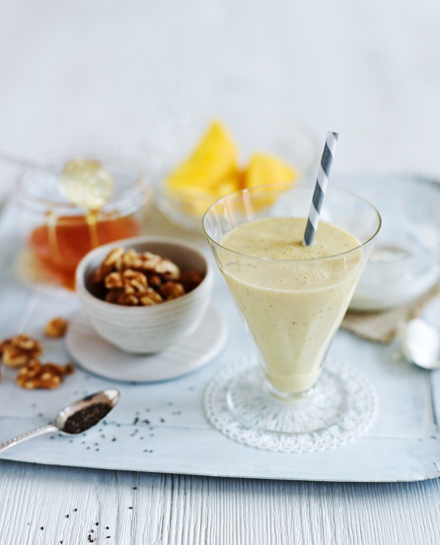 A nutrient rich milkshake, nuts, honey and mango