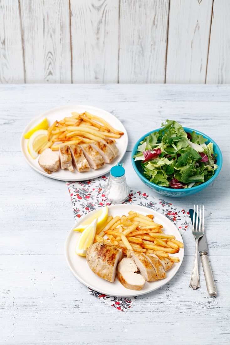 Grilled chicken fillet with chips and a salad