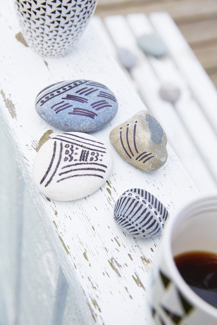 Pebbles painted with patterns of stripes