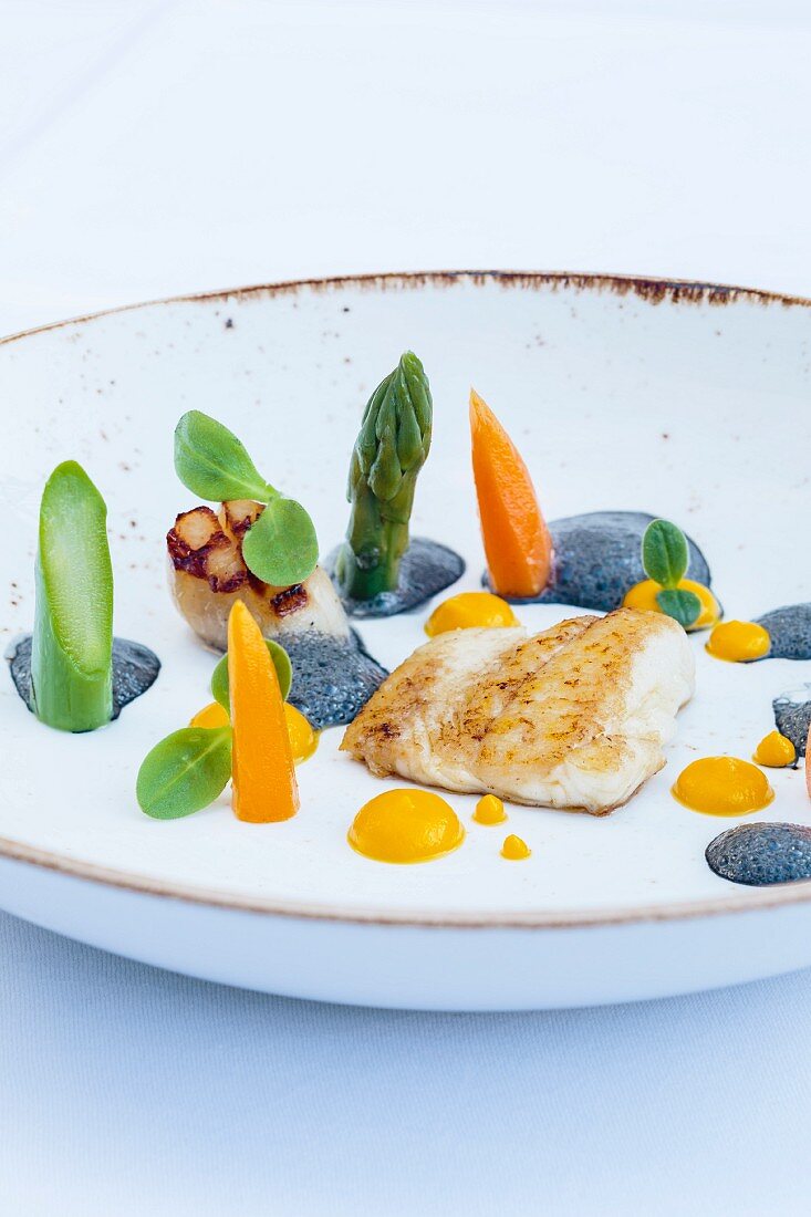 Plaice fillet with scallops, carrot cream and black garlic butter