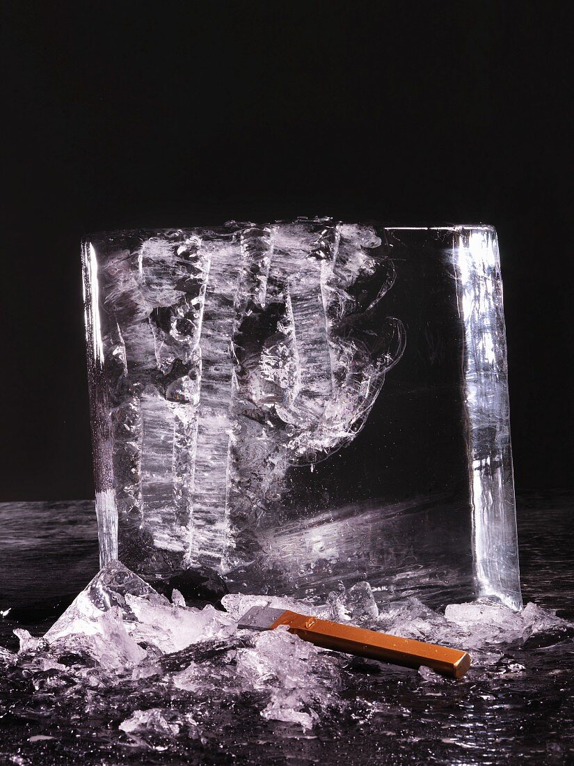 A chopped block of ice against a black background