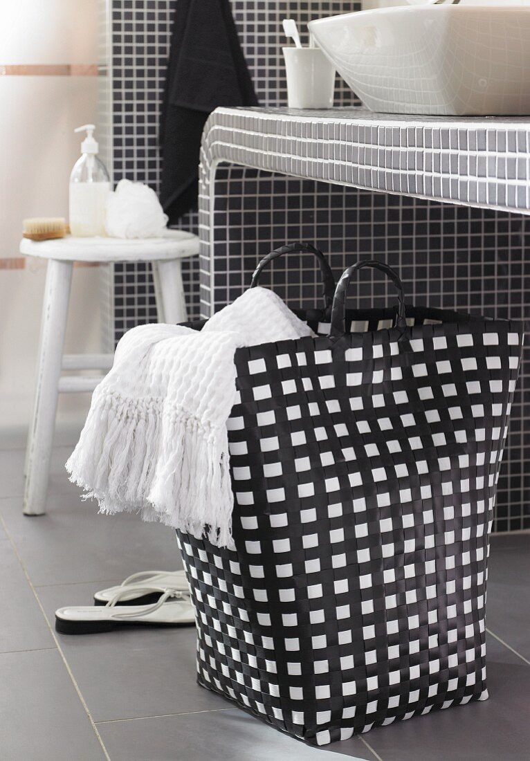 Black and white laundry bag below washstand