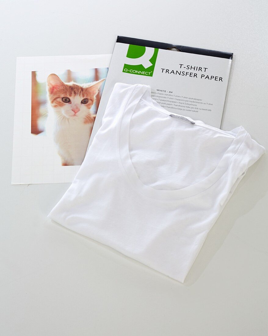 Presents being made: a cat photo on transfer paper being ironed on to a shirt