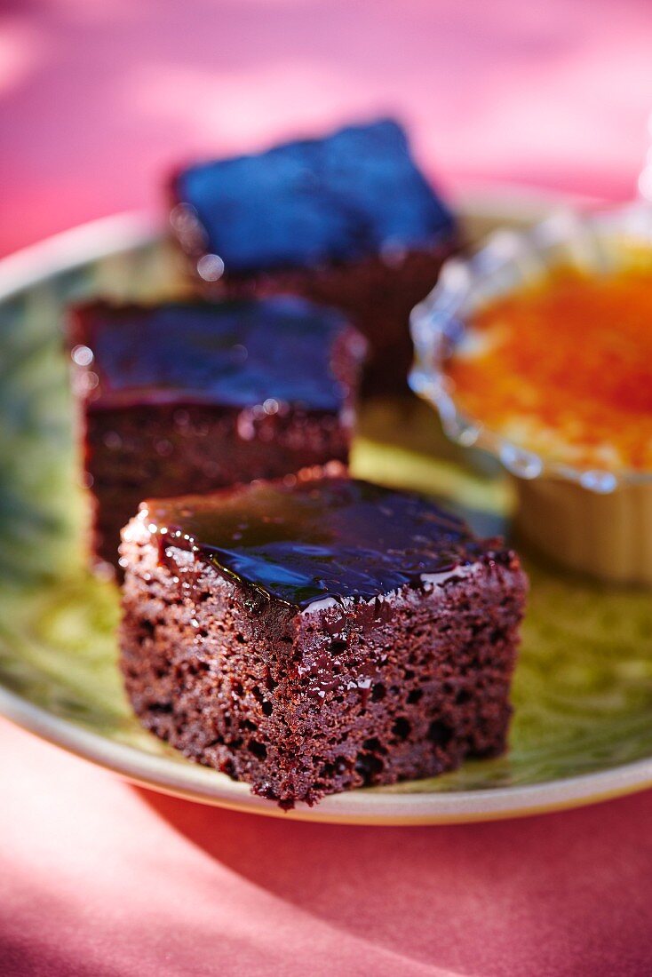 Three slices of chocolate cake with chocolate glaze