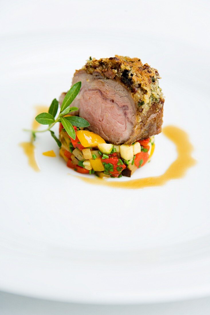 Saddle of lamb with a thyme and olive crust on vegetable tartare