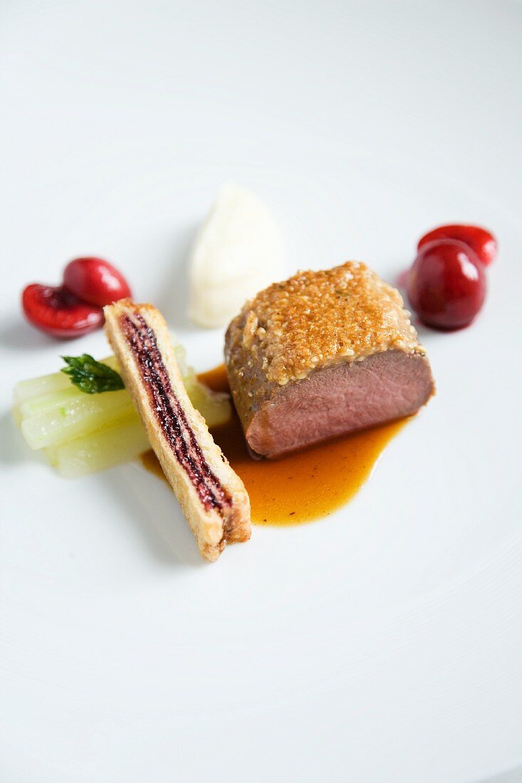 A venison medallion in a pine nut crust with French toast and red wine cherries