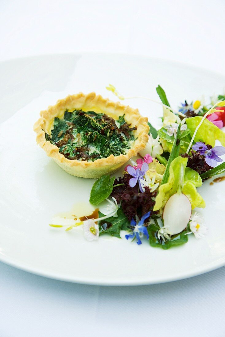A mini stinging nettle tart with a wild herb salad
