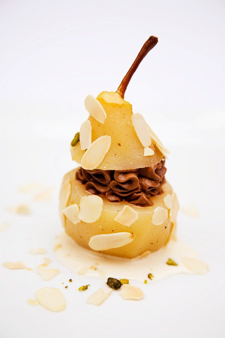 An almond pear filled with chocolate mousse and pistachio ice cream