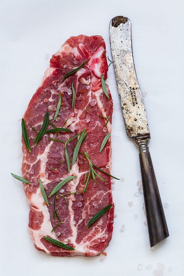 A slice of beef with rosemary