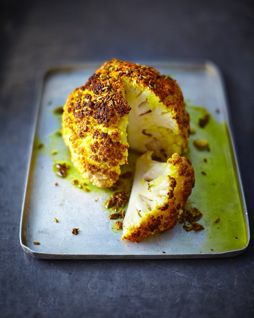 Roasted cauliflower seasoned with turmeric powder and aniseeds (sliced)