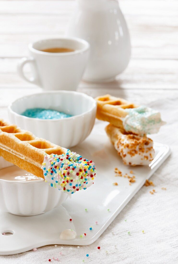Waffle sticks with white chocolate and sugar sprinkles